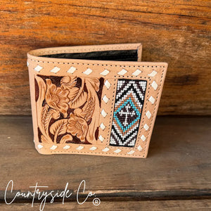 Tan leather men's wallet with embossed floral pattern and beaded cross design.