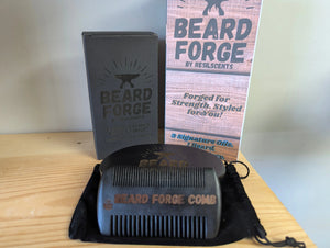 Beard Forge grooming set with comb, brush, storage bag, and presentation box on wood surface, showcasing the product's complete package.