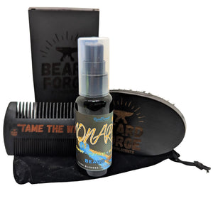 Beard Forge beard grooming set: oil bottle, wood comb and brush, black velvet bag, and box.
