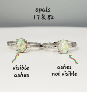 Two memorial rings: one opal ring with visible ashes, and one with ashes not visible, both set in sterling silver.