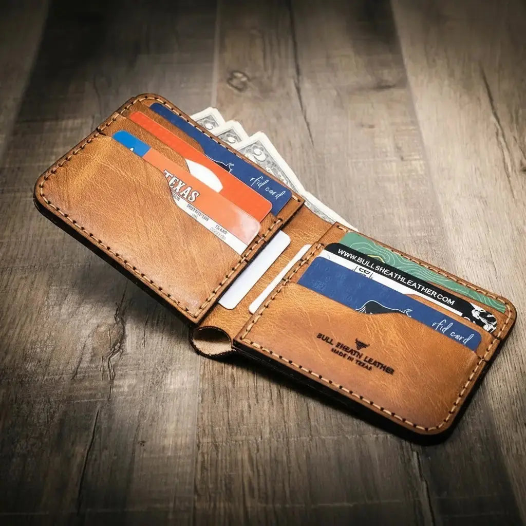 Brown leather bifold wallet with cards and cash displayed on a wooden surface.