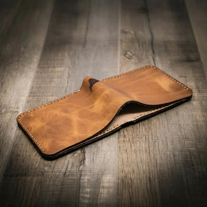 Brown distressed leather bifold wallet with visible stitching.