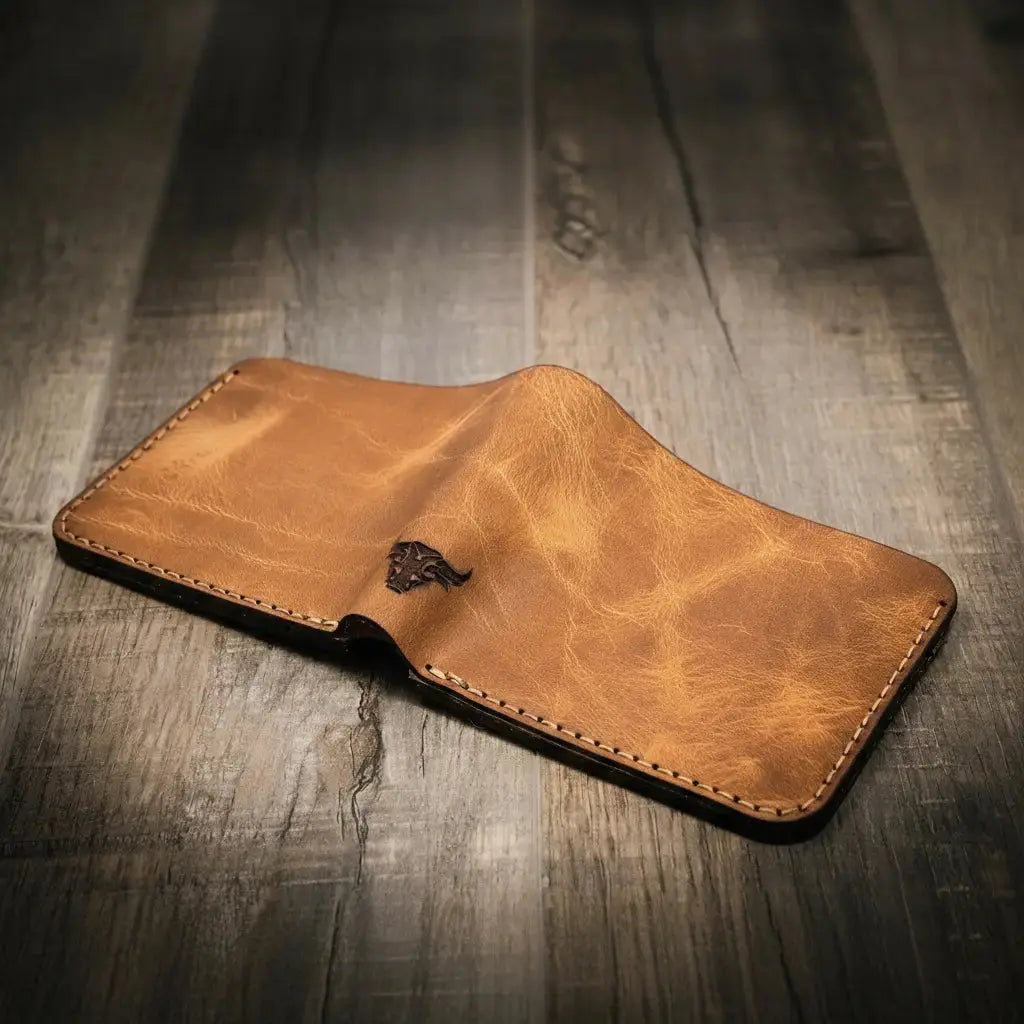 Brown leather bifold wallet with embossed bull logo, shown open.