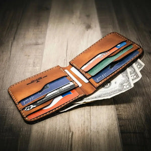 Leather bifold wallet with cards and US dollar bills inside