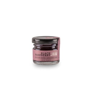 Small glass jar of black raspberry jam with a label indicating it's Kentucky grown.