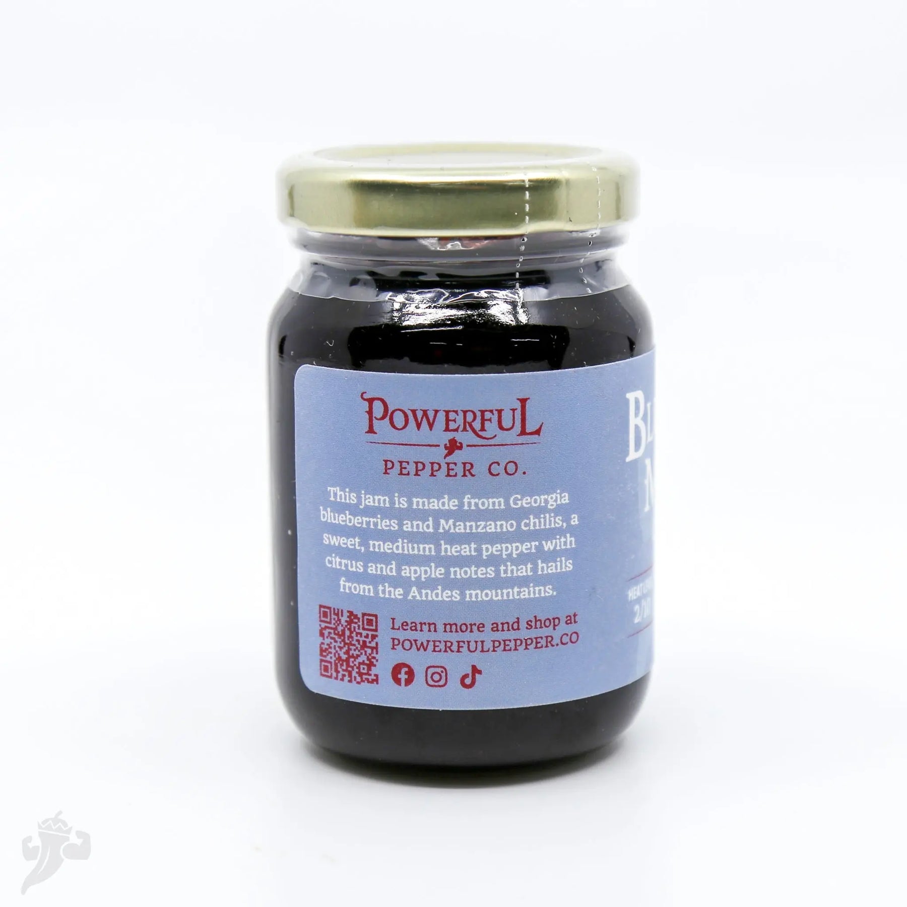 Blueberry Manzano Chili Jam from Powerful Pepper Co. in a glass jar.