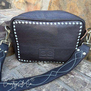 Dark brown genuine leather purse with boot stitch detail and Countryside Co. branding.