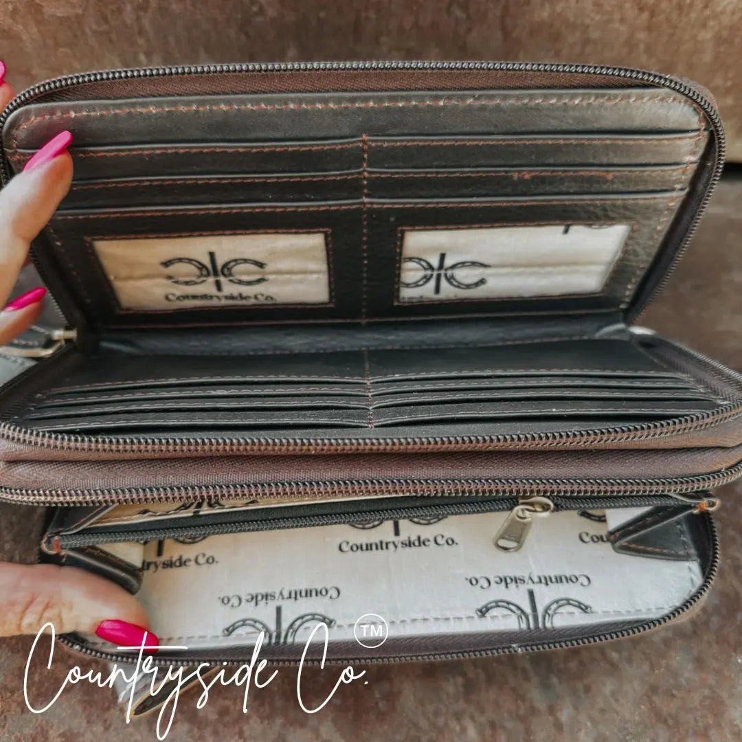 Brown leather wallet wristlet with multiple card slots and zipper closure.