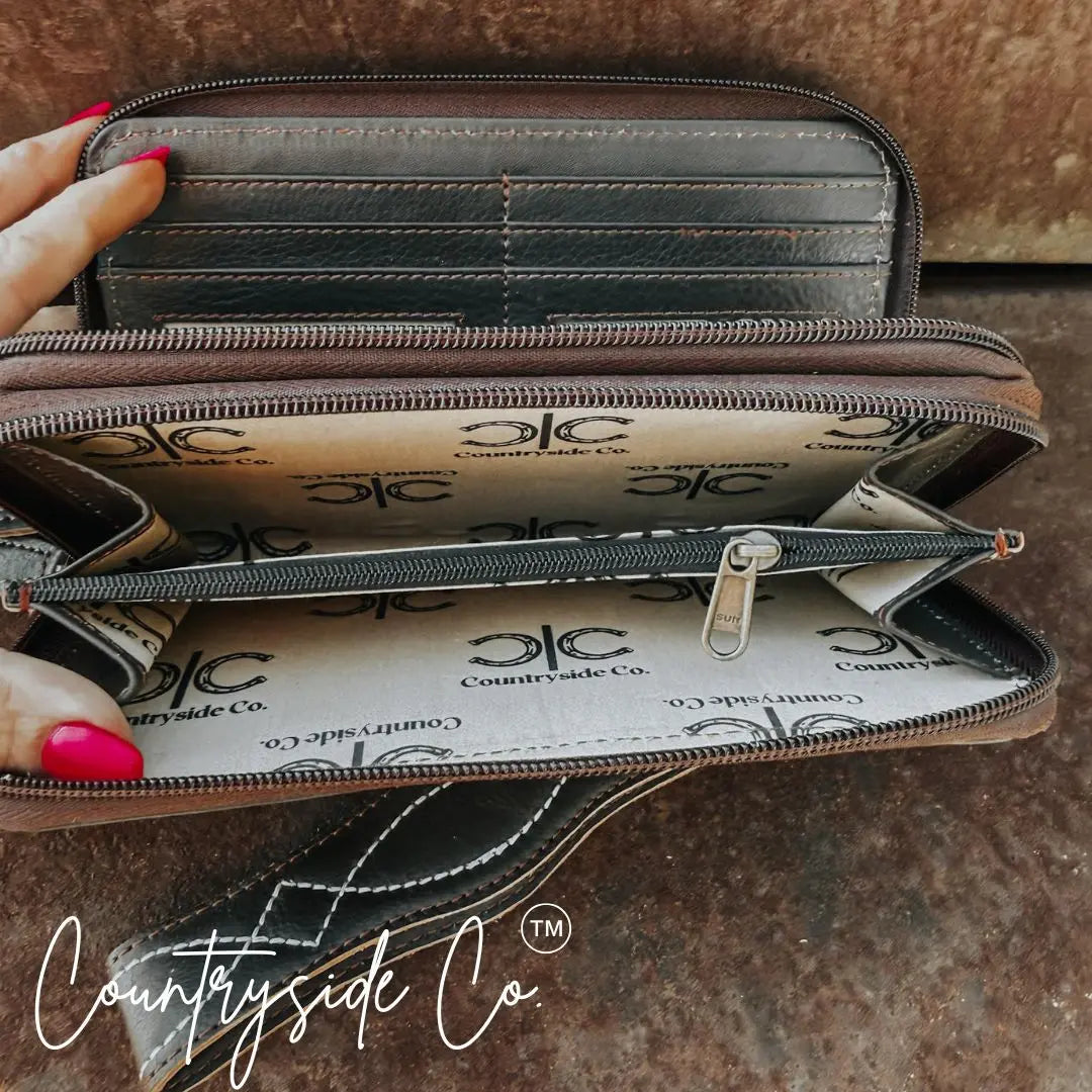 Brown leather zipper wallet with wristlet and interior card slots.