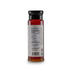 Bottle of bourbon barrel aged maple syrup with nutrition label and ingredient information.
