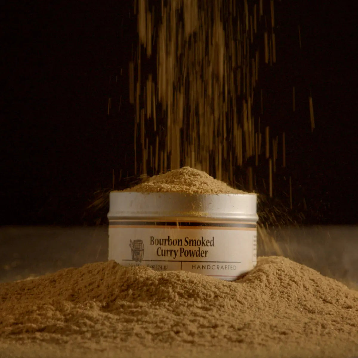 Bourbon Smoked Curry Powder tin with seasoning falling onto the label