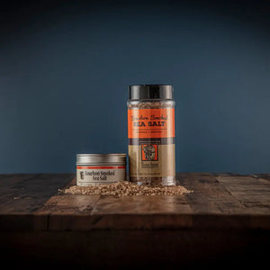 Bourbon Smoked Sea Salt in tin and shaker on wooden table