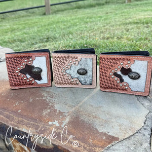 Three men's cowhide wallets with tooled leather and conchos.