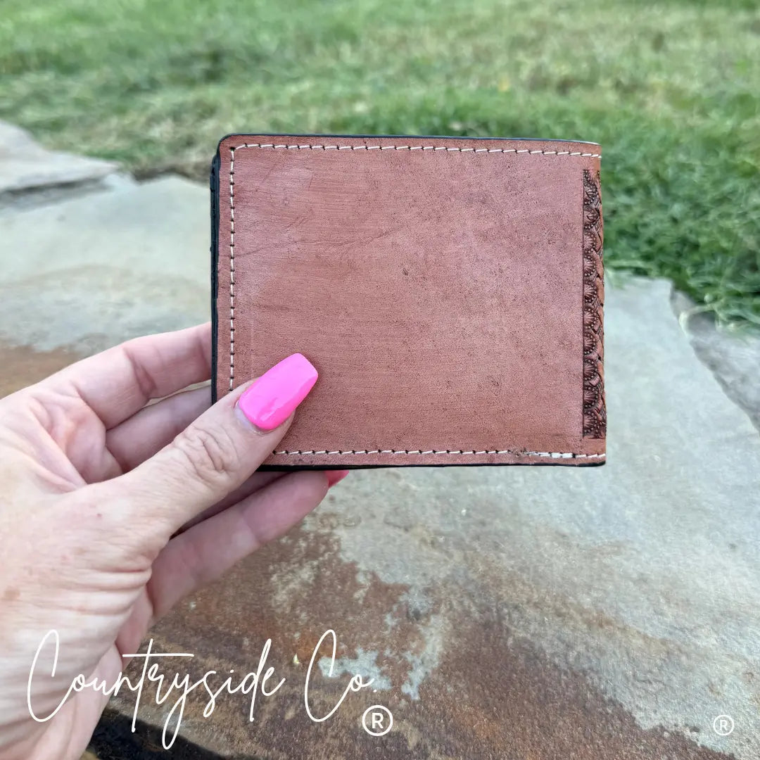 Buckhorn cowhide men's wallet with tooled leather front and plain leather back.