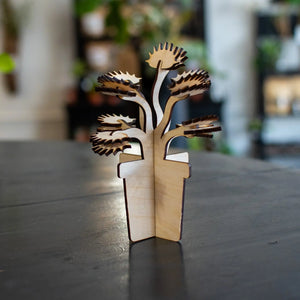 Laser-cut wooden Venus fly trap plant in a pot.