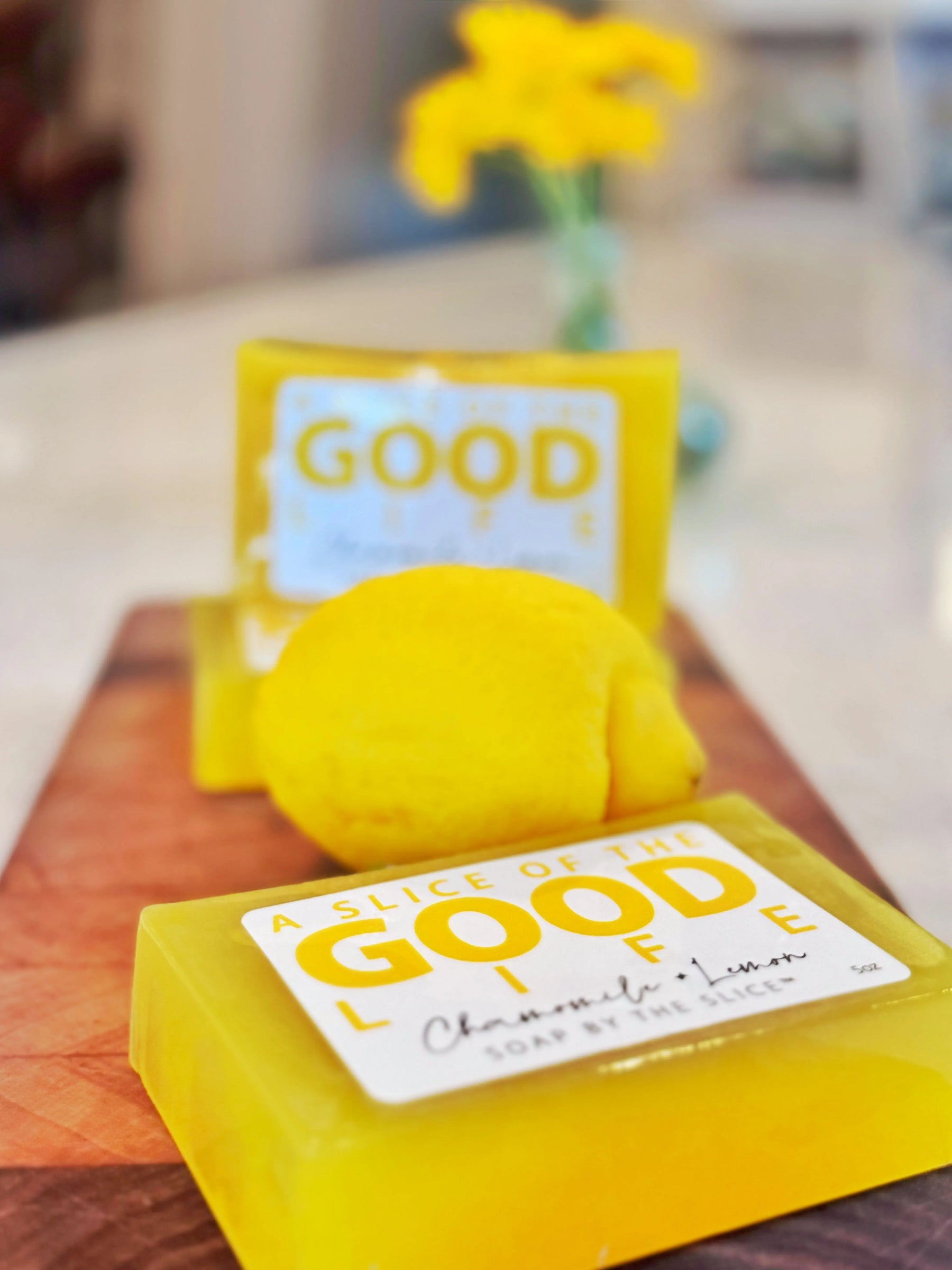 Yellow soap bar with a lemon slice and "GOOD LIFE" label, chamomile and lemon scented.