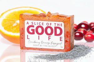 Cranberry orange poppy seed soap slice with orange and cranberries