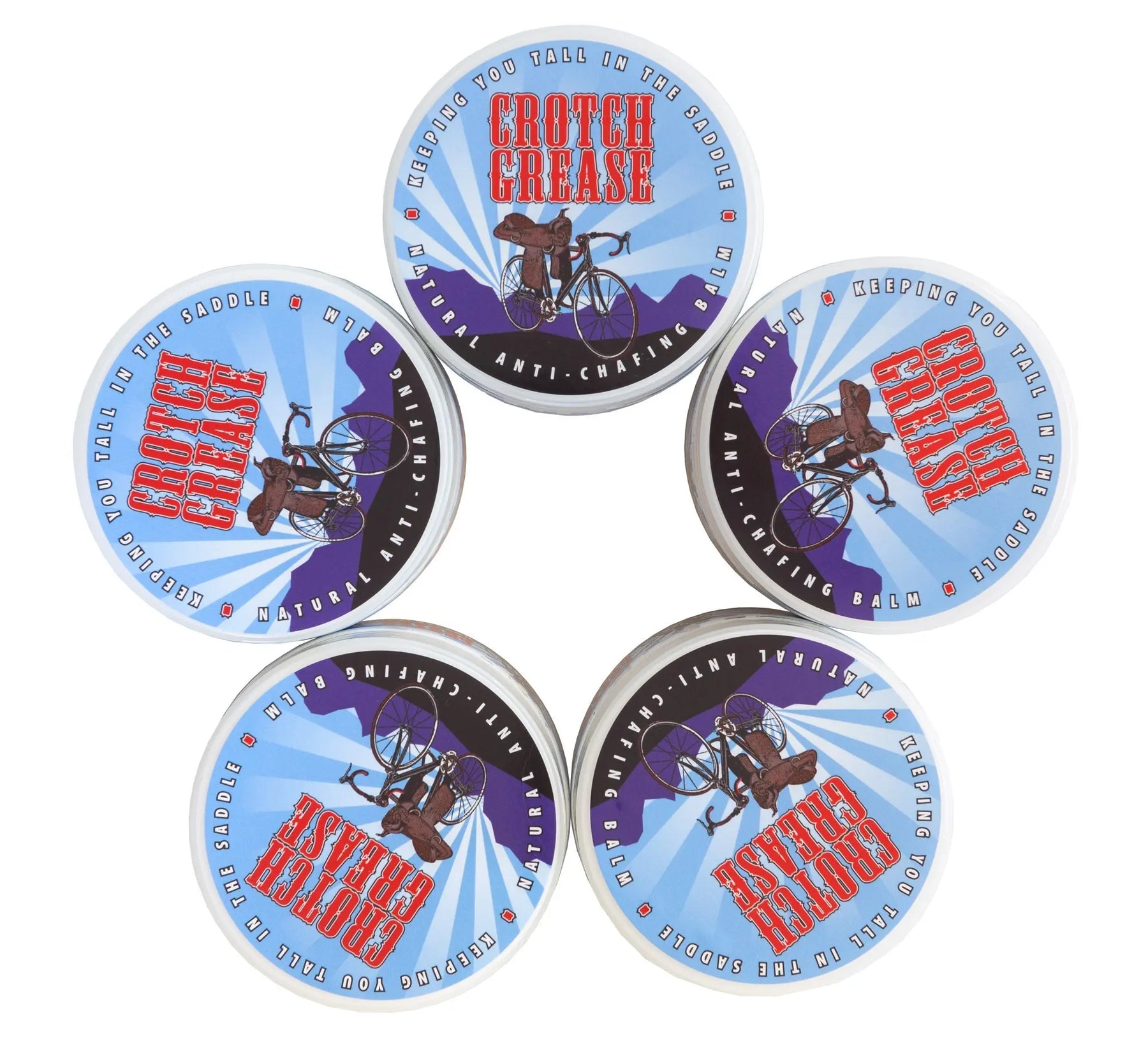 Five round tubs of Crotch Grease anti-chafing balm with cycling imagery and text.