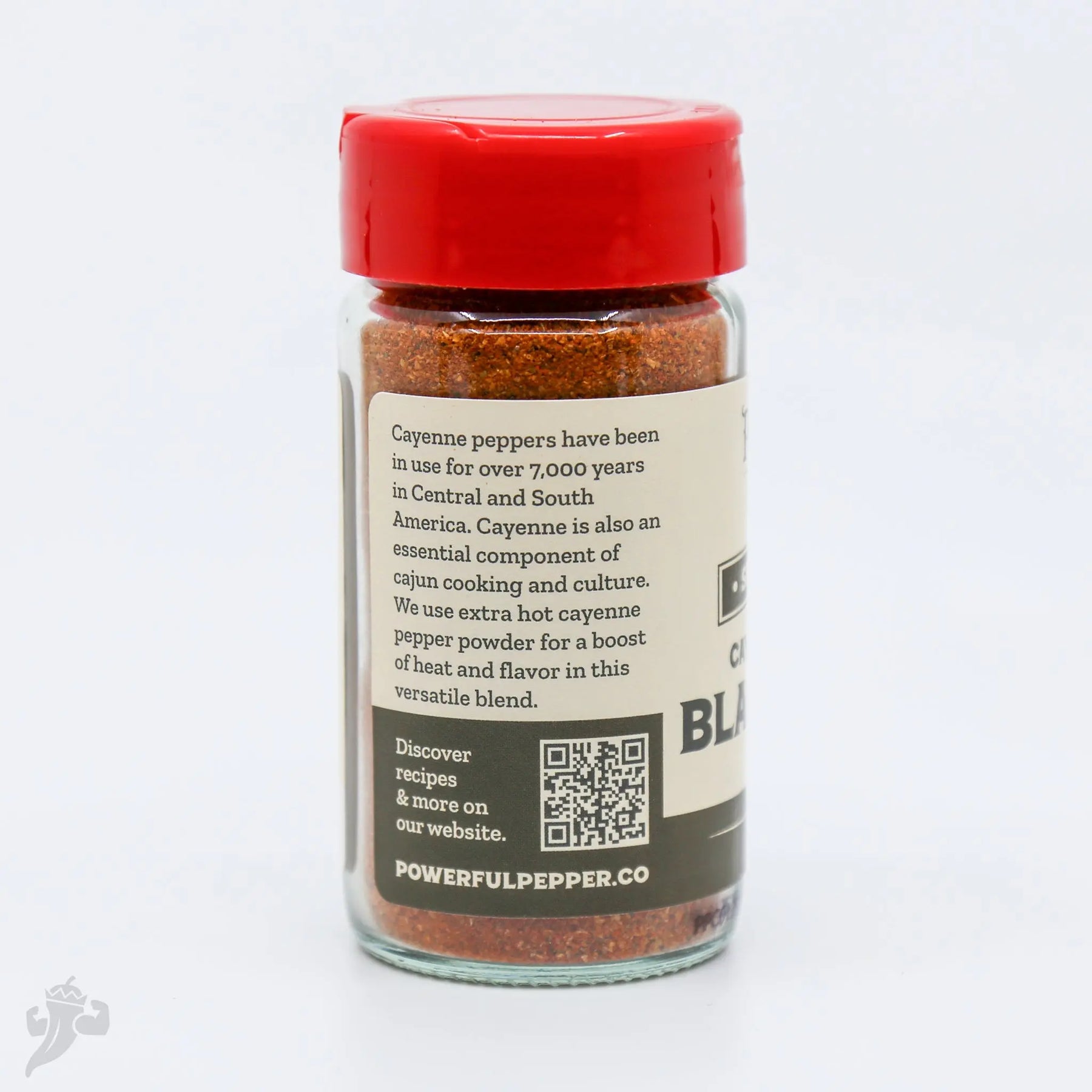 Cajun Blackening Seasoning spice blend in a clear glass jar with a red lid from Powerful Pepper Company.