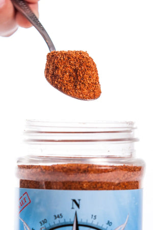 Compass Point Cajun Blend Spice - Main Street Collective: Spoon of Cajun Seasoning over jar - Flavorful, All-Purpose Low Salt Blend.