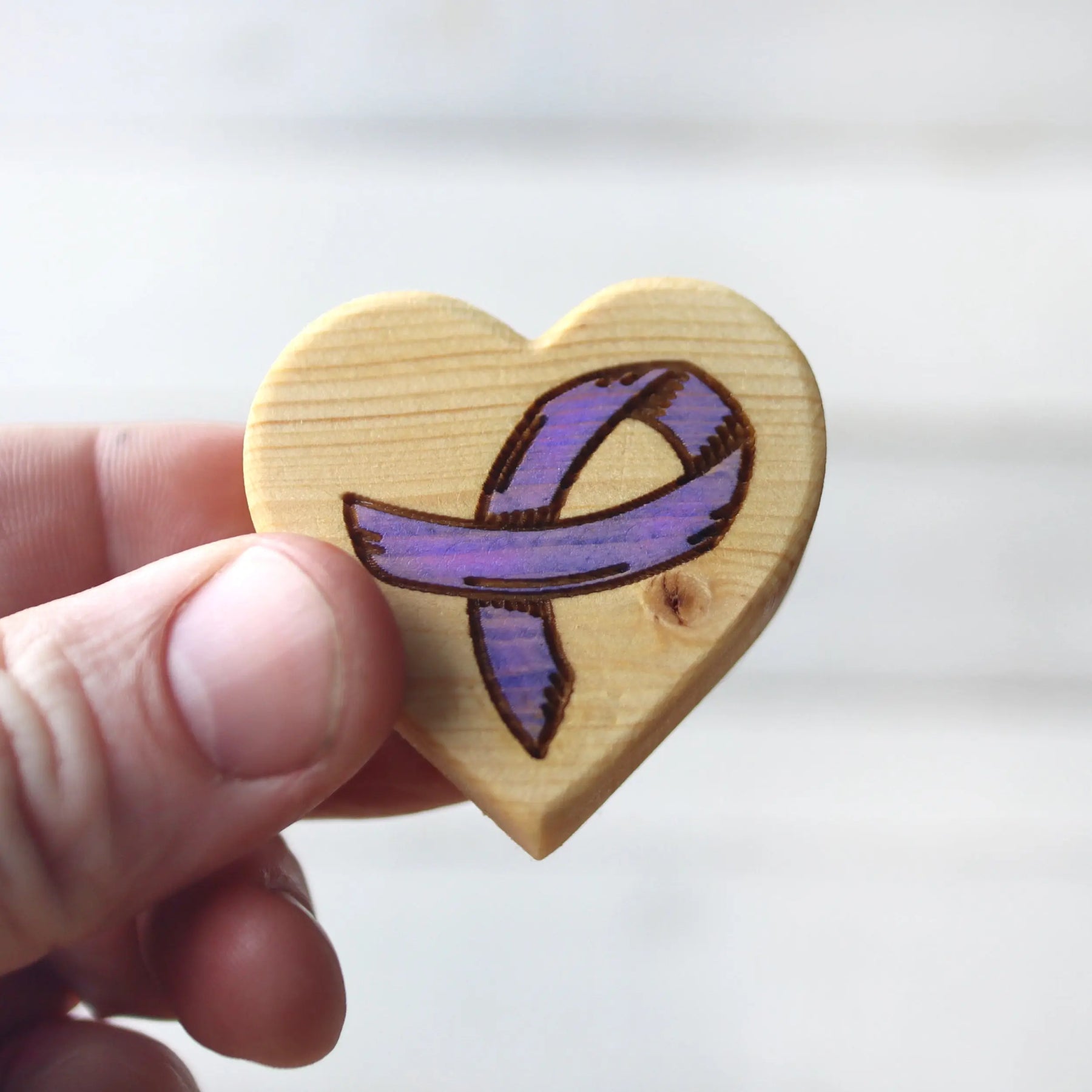 Wooden heart with purple awareness ribbon for cancer support