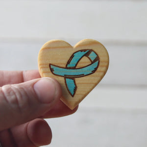 Wooden heart charm with a teal awareness ribbon design.