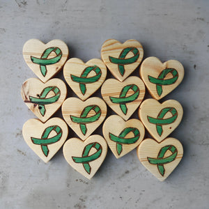 Wooden hearts with green cancer awareness ribbons