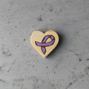 Wooden heart with a purple awareness ribbon engraving.