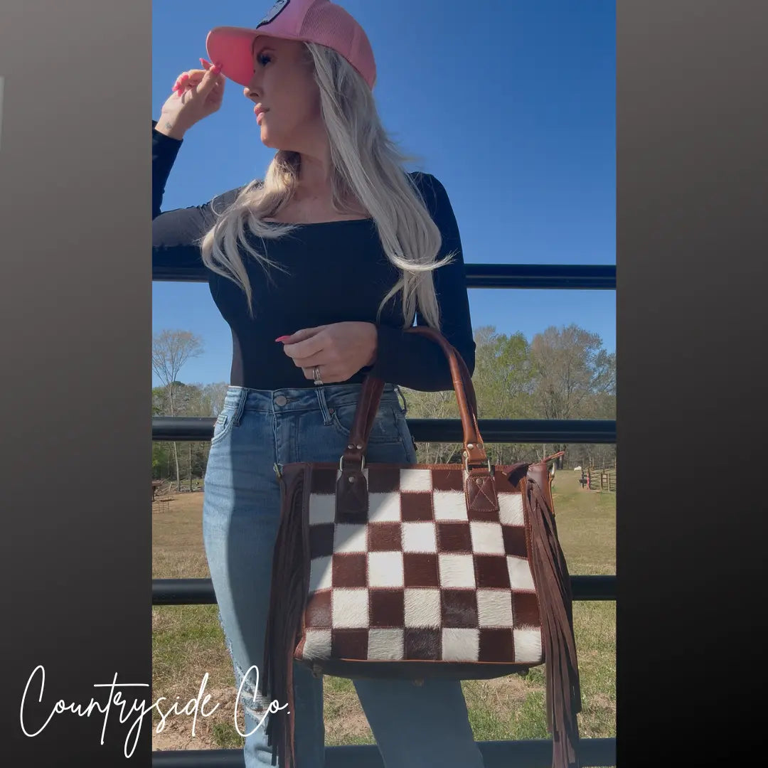Brown and white checkered cowhide concealed carry purse with fringe by Countryside Co.