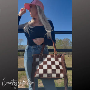 Brown and white checkered cowhide concealed carry purse with fringe by Countryside Co.