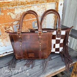 Brown leather and cowhide checkered tote bag with fringe