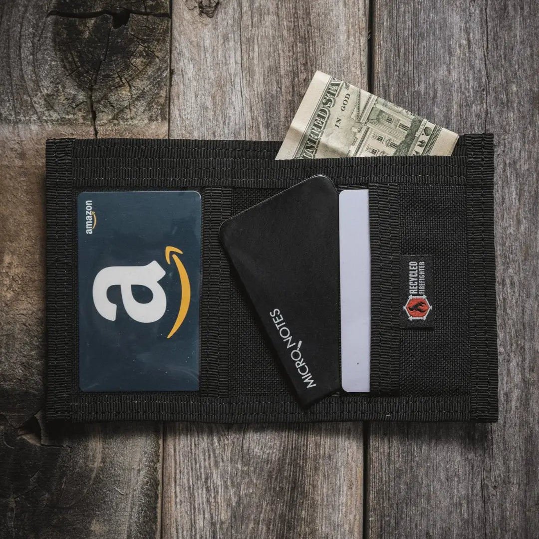 Black fire hose wallet with Amazon gift card, currency, and cards