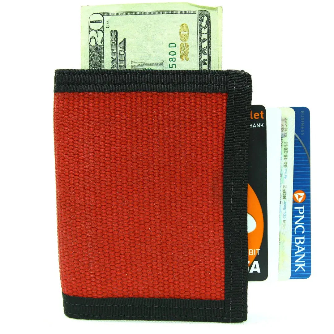 Red canvas wallet with a 20-dollar bill and bank cards inserted.