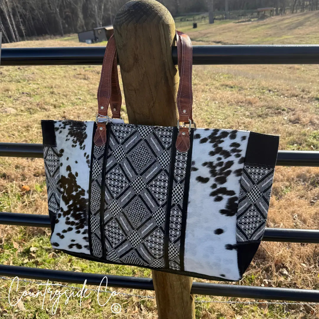 Charlene weekender bag with cowhide and geometric textile pattern on leather handles.