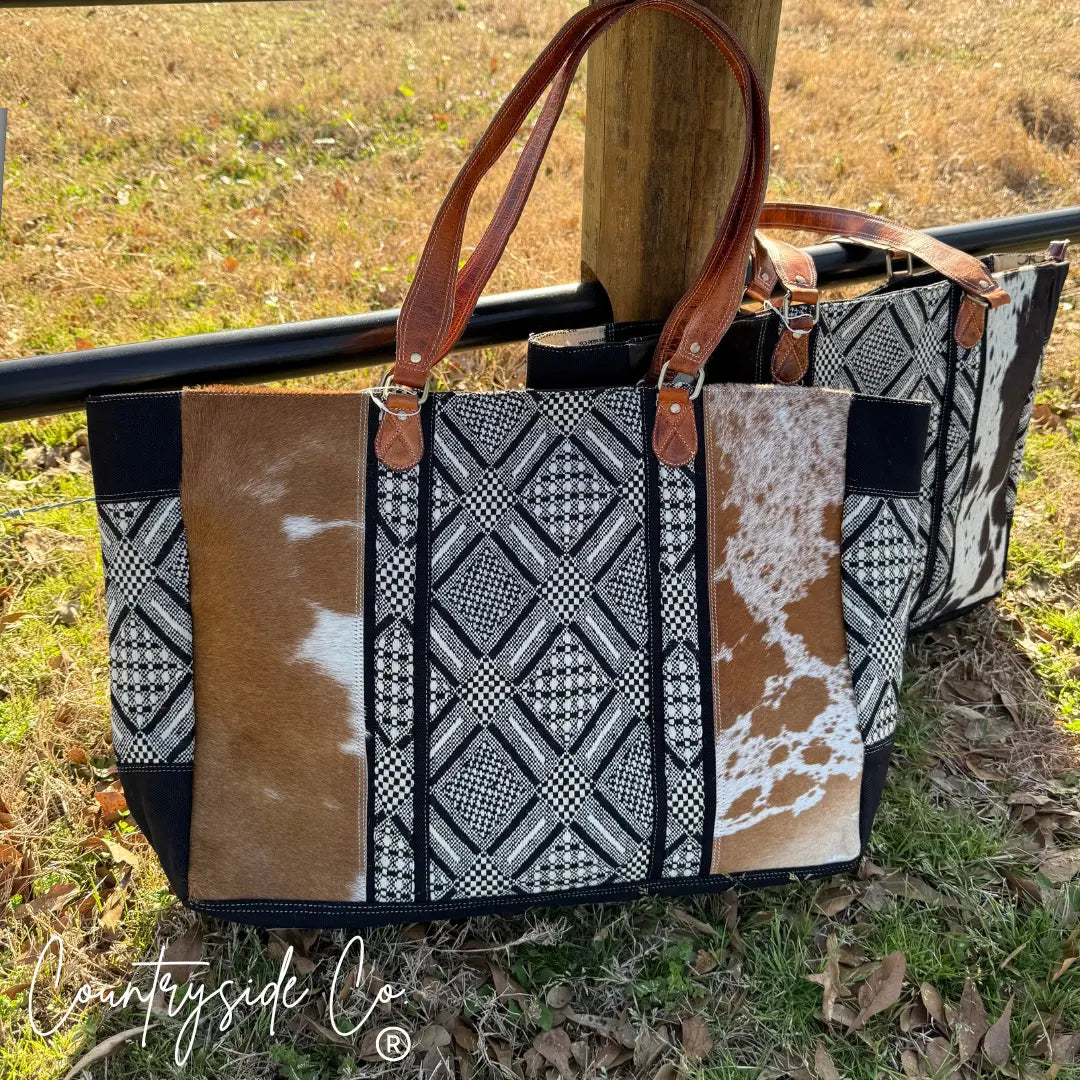 Charlene Cowhide Weekender Bag with geometric textile pattern and leather straps.