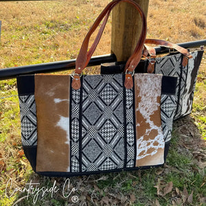 Charlene Cowhide Weekender Bag with geometric textile pattern and leather straps.