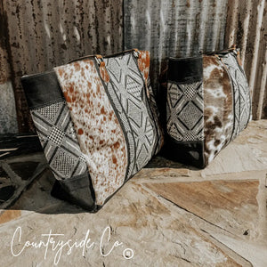 Charlene Cowhide Weekender Bag with brown and white cowhide and black and white textile patterns.