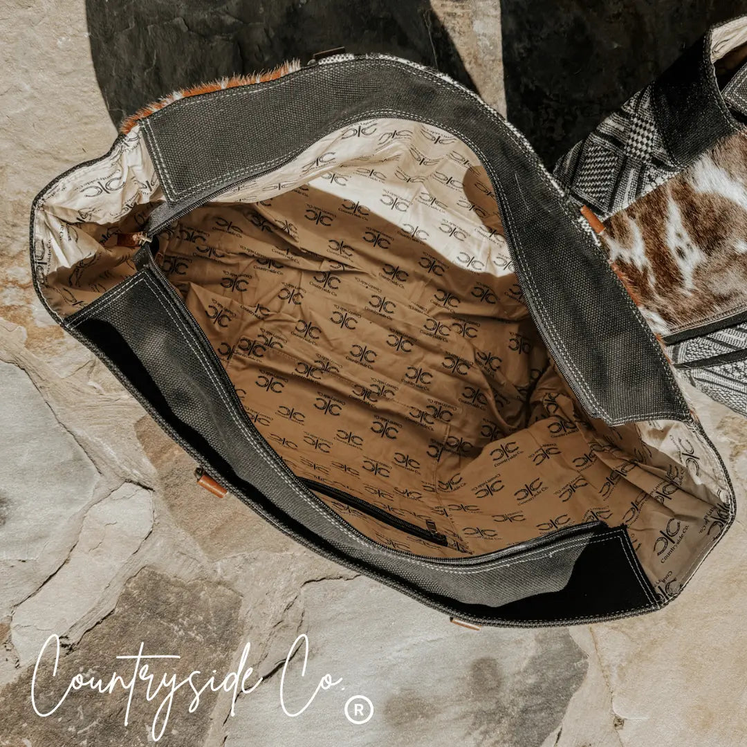 Countryside Co. Charlene cowhide weekender bag interior with logo lining.