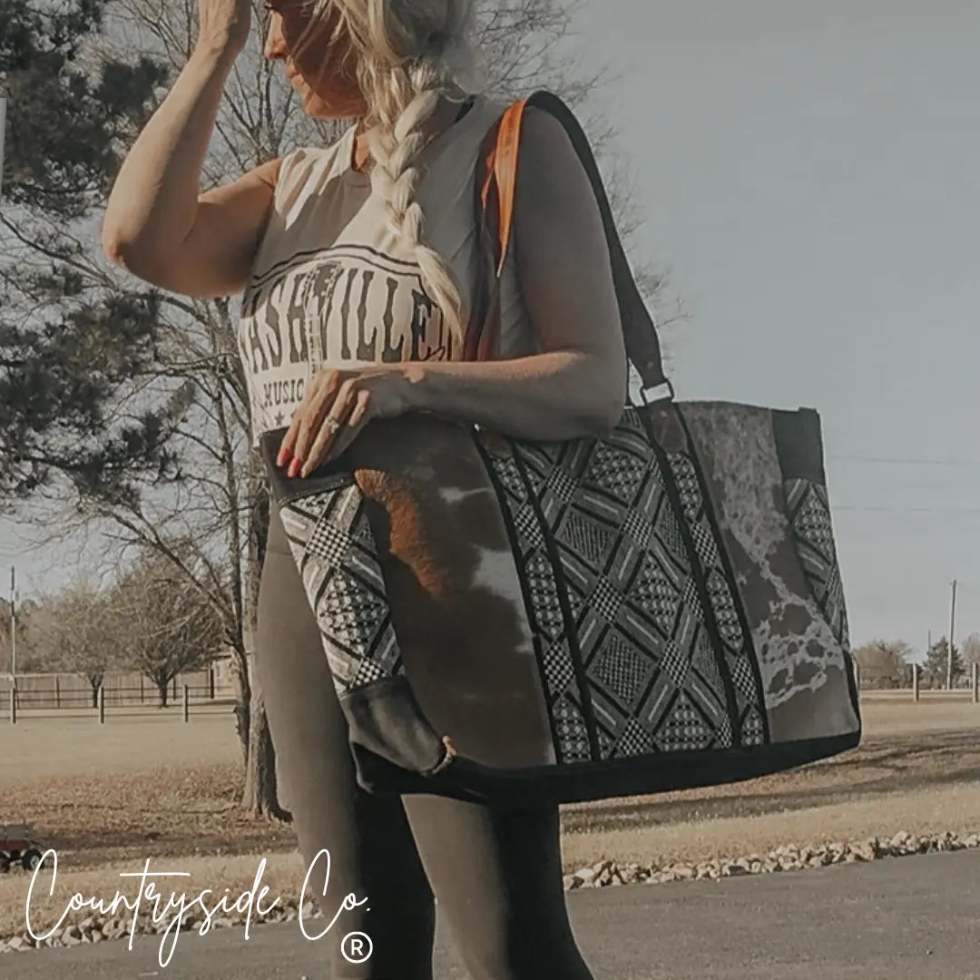 Charlene Cowhide Weekender Bag with geometric pattern and ranch leather handles.