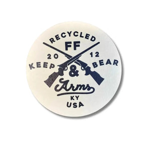Circular coaster with crossed revolvers, "RECYCLED FF", "KEEP 20 12 BEAR", and "Arms KY USA" text.