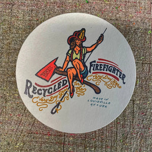 Round coaster with a distressed illustration of a female firefighter riding an axe.