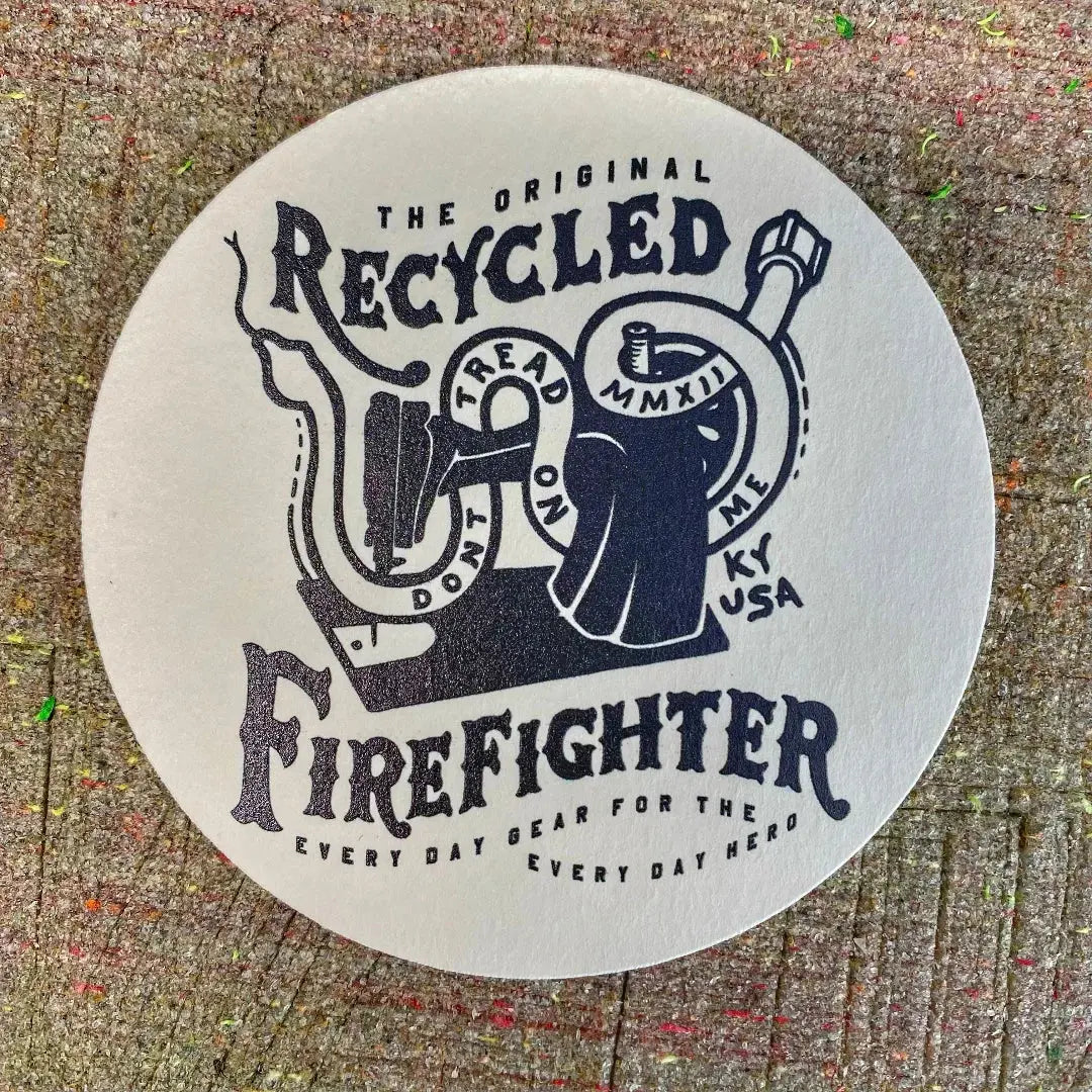 Circular coaster with vintage-inspired "Recycled Firefighter" graphics.