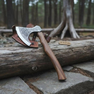 Damascus steel axe head with leather handle on rustic wood surface