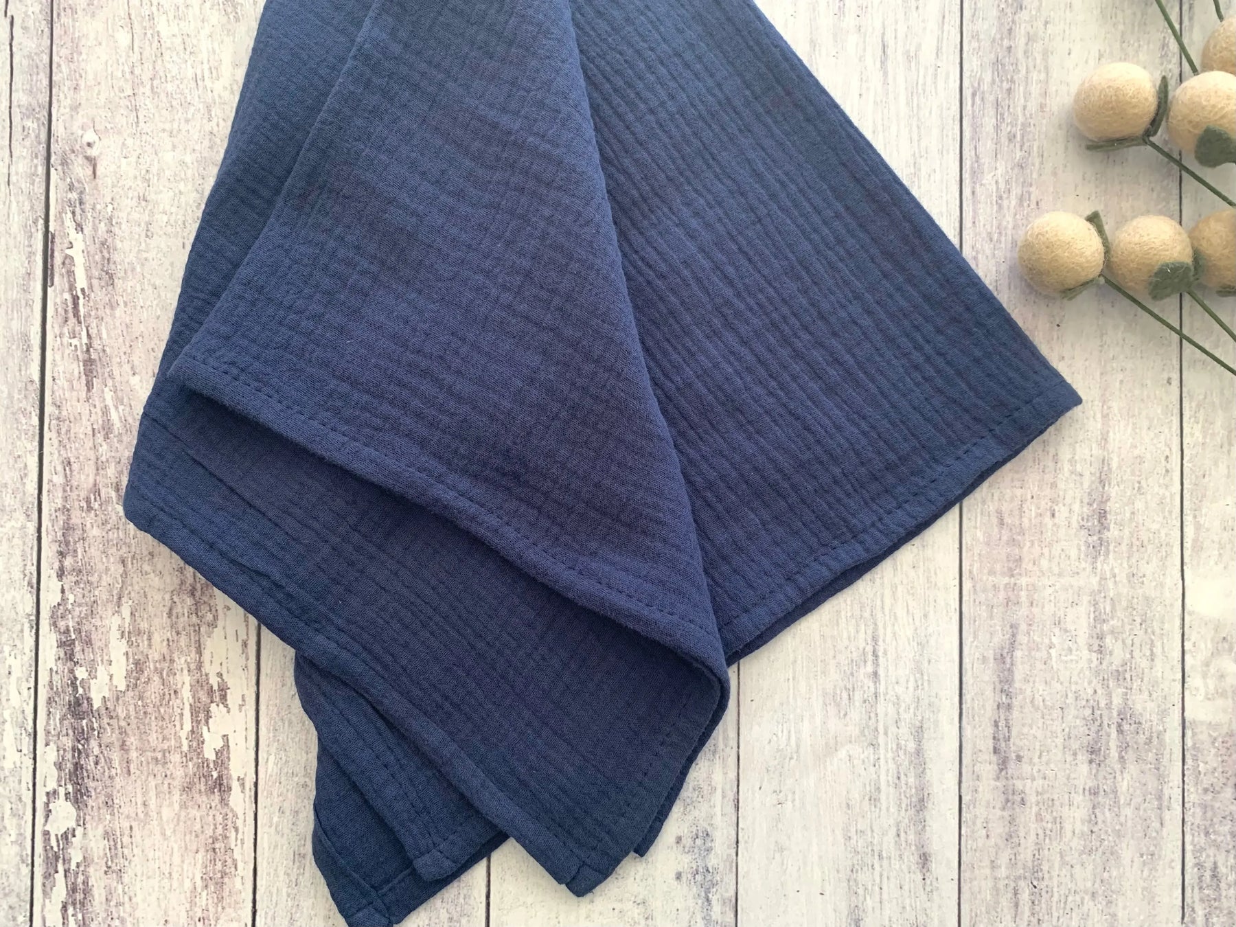 Dark blue cotton napkins with a crinkle texture.