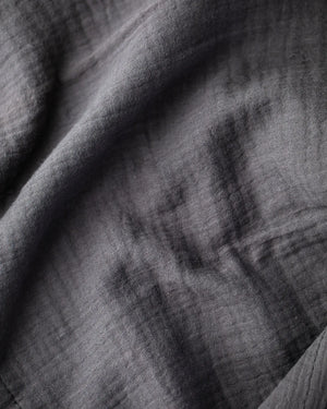 Dark gray textured crinkle cotton fabric close-up.