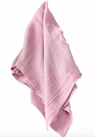 Pink crinkle cloth napkin with textured surface.