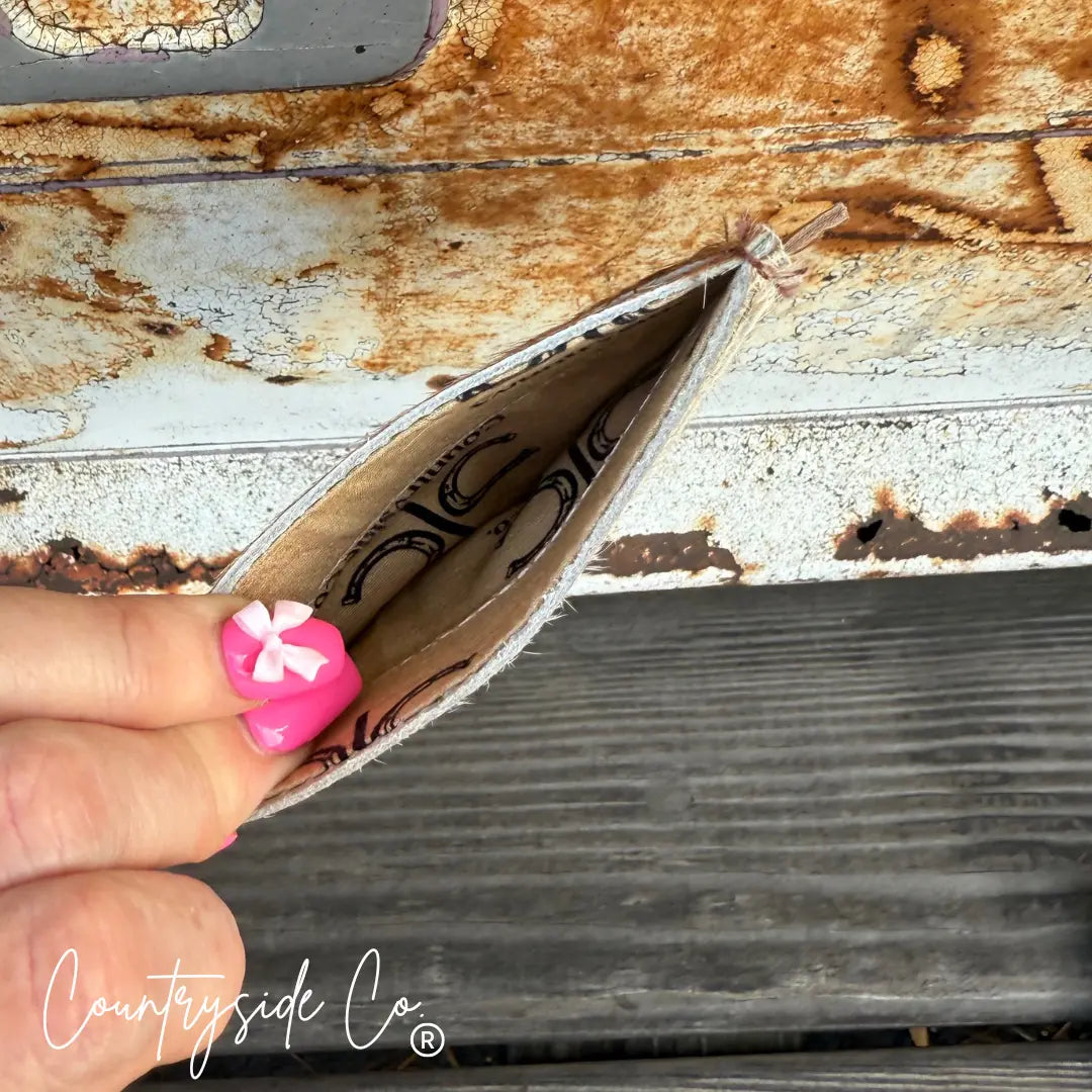 Cowhide credit card holder by Countryside Co. with horseshoe print interior.