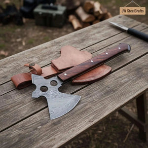 Damascus steel axe head with wood handle on rustic wood surface