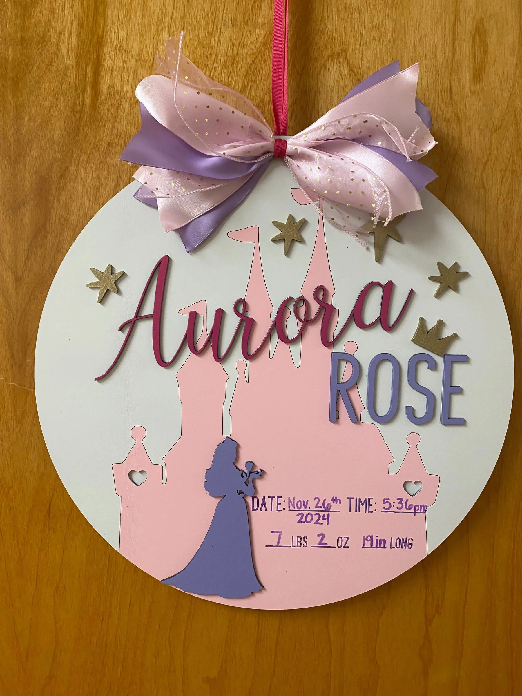 Custom baby name sign "Aurora Rose" with princess castle and birth details.