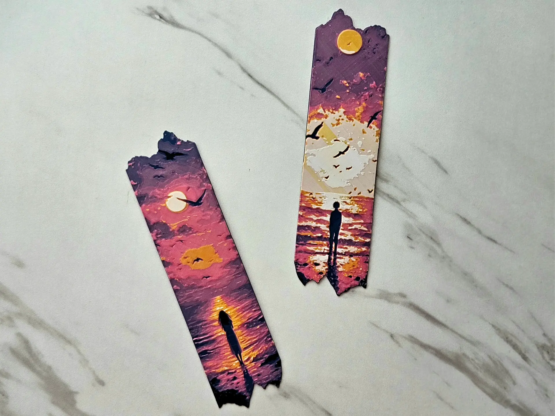 Two ocean sunset bookmarks with silhouette figures